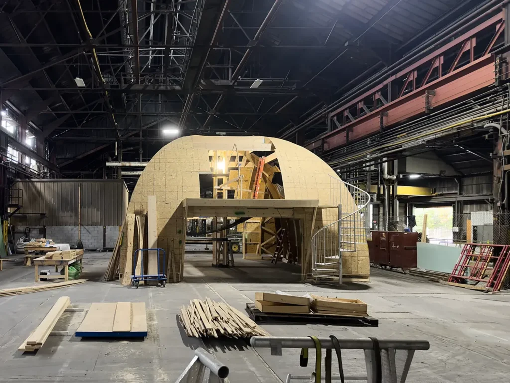 Modular home being assembled inside large rental space