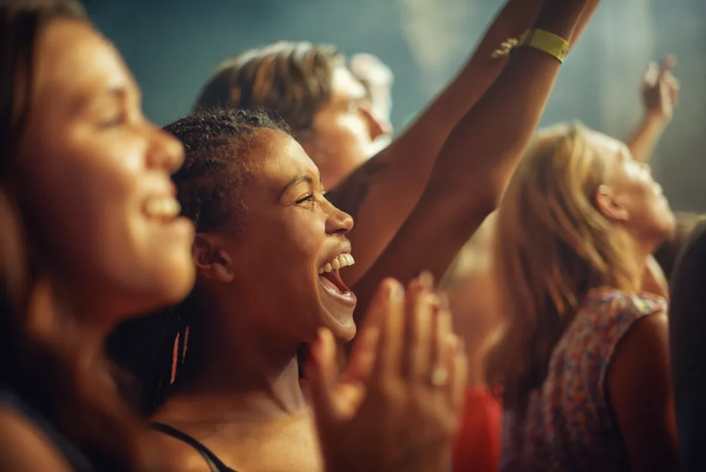 Young girls celebrate at a music concert